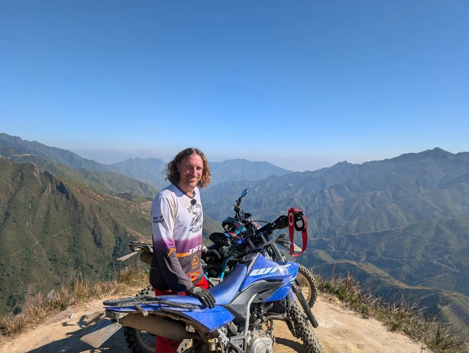 Tour guide sits on a swing at a mountaintop in Ta Xua on an off-road tour